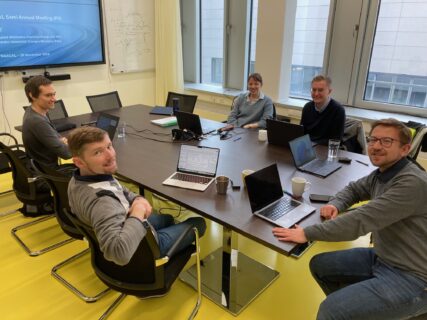 The group gather in PULS' meeting room